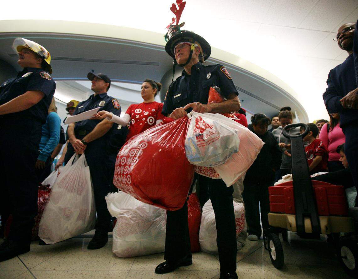 Mickey Kaitangian, center, prepares to hand out gifts to children at Valley Children’s Hospital during a Christmas visit in 2010.