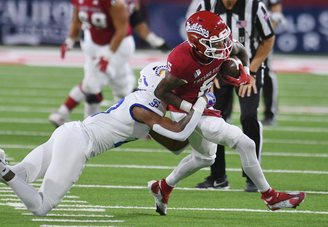 Fresno State’s Jalen Moreno-Cropper is tackled by San Jose State’s Nehemiah Shelton, left, in first half action Saturday, Oct. 15, 2022 in Fresno.