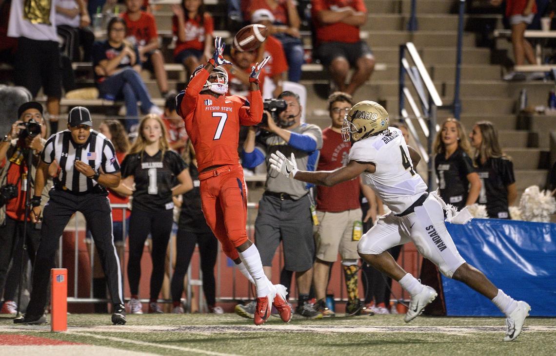 Fresno State wideout Derrion Grim, left, reaches up to grab a touchdown pass with Idaho’s Denzal Brantley defending in the Bulldogs’ 79-13 season-opening victory at Bulldog Stadium on Saturday, Sept. 1, 2018.