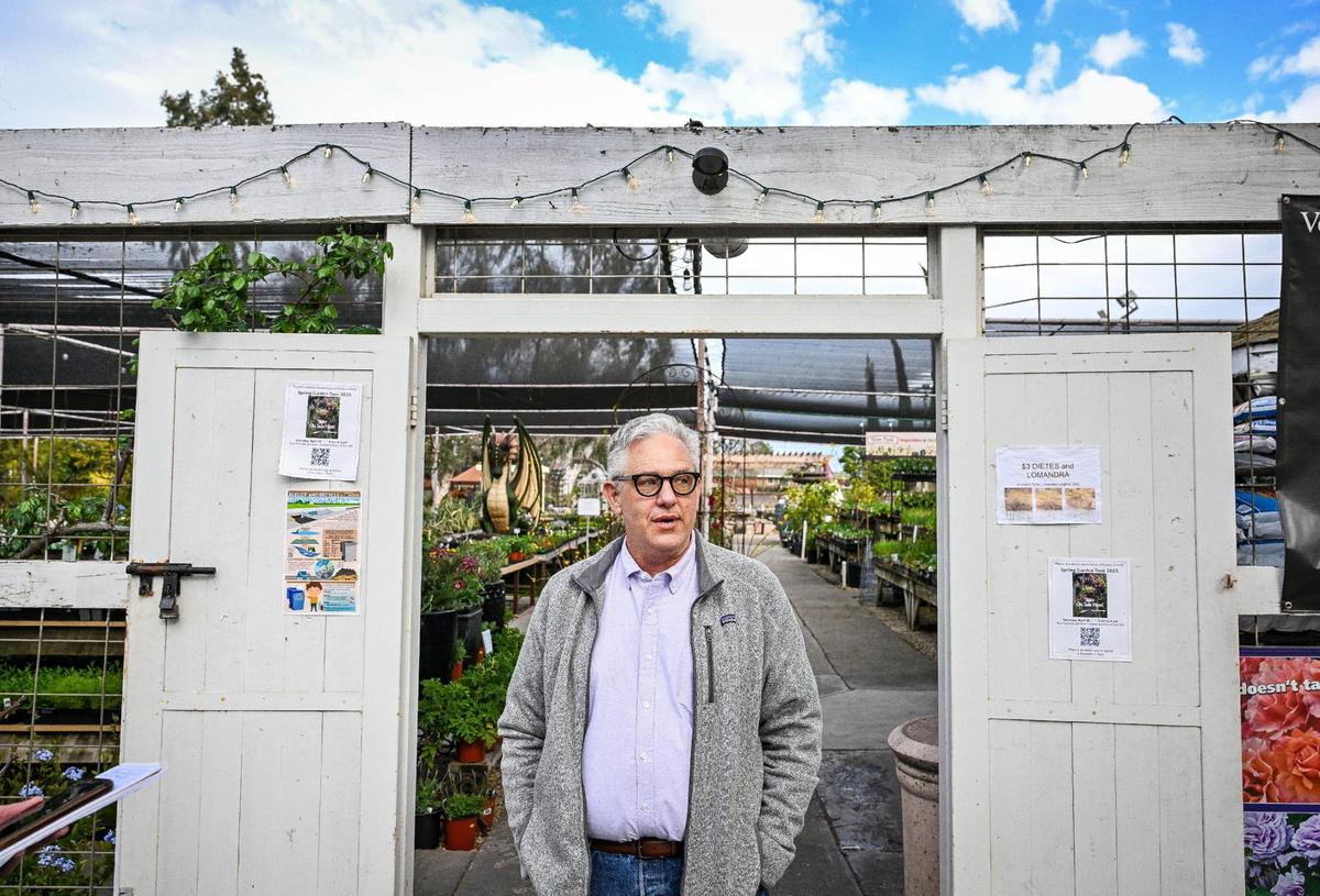 Scott Miller, owner of Gazebo Gardens nursery in Fresno, stands at its entrance while talking about the well-known business in the center of town.