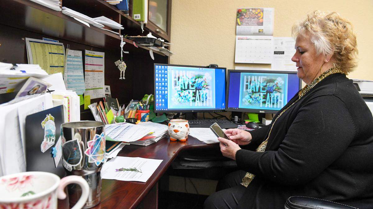 Nancy Pierce Director of Health Services at the Fresno American Indian Health Project checks her phone while working in her office in Fresno on Wednesday, March 25, 2021.