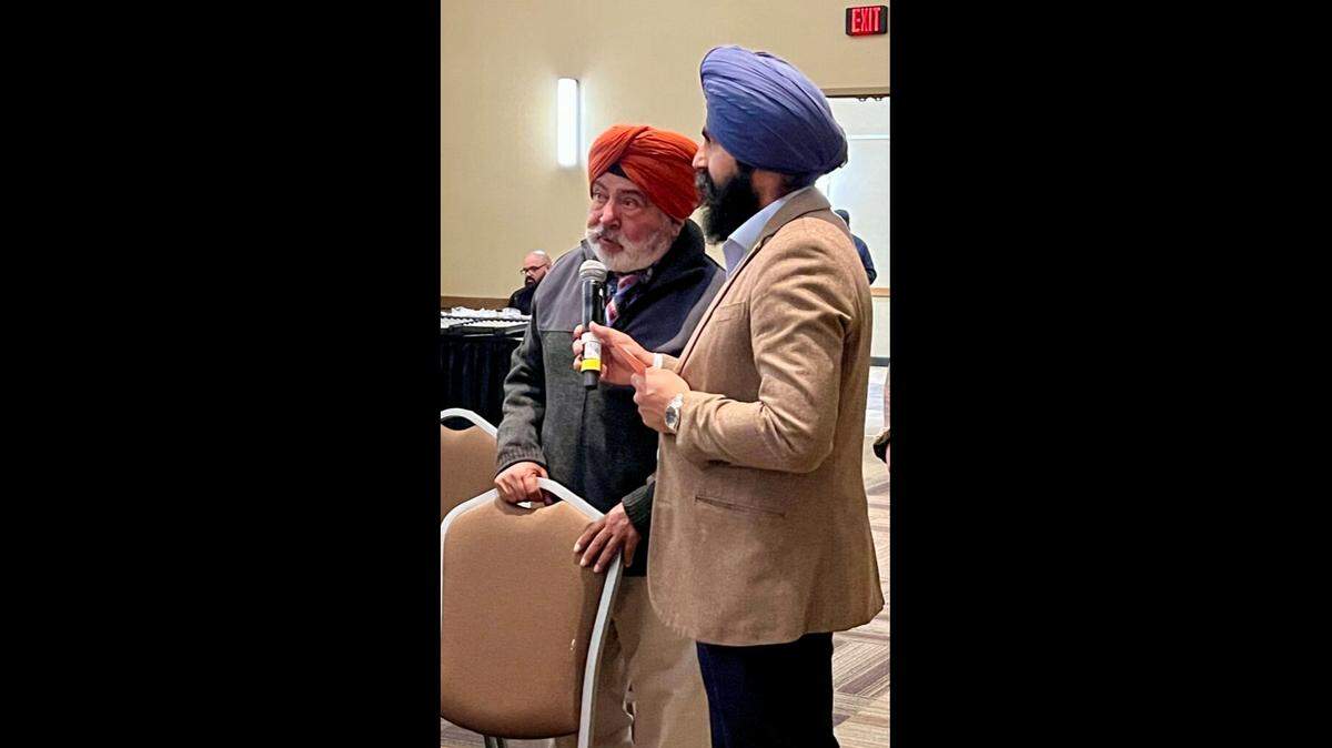 Dayadeep Singh, left, a Selma farmer, addresses a panel during a workshop organized by Punjabi growers Dec. 5 in Visalia. Assisting with interpretation is Bhajan Singh Sihota, a farmer with land in Selma southeastern Tulare County.