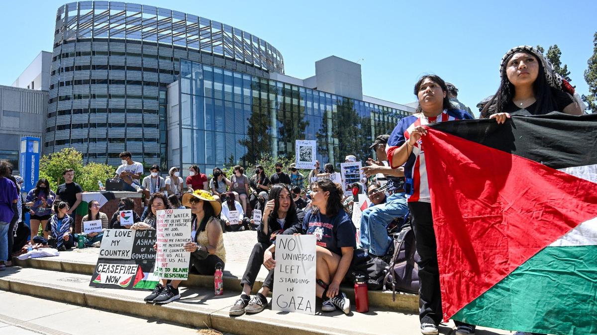 Students and other supporters gather in the Free Speech area at Fresno State while holding Palestinian flags and signs during a peaceful pro-Palestinian sit-in organized by Students for Palestinian Liberation on Wednesday, May 1, 2024.