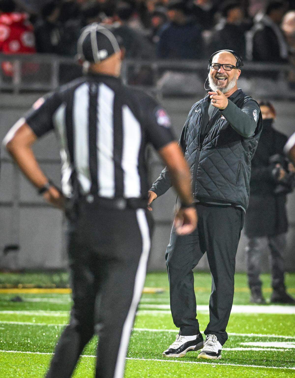 Central East head coach Kyle Biggs has a laugh with an official during their Central Section Division I-AA championship game against Clovis at Deran Koligian Stadium on Friday, Nov. 21, 2025.