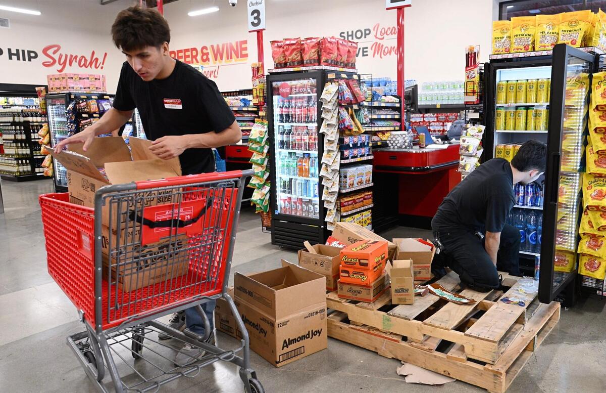 Staff stock items at the new Grocery Outlet located at Nees and Willow avenues Tuesday, July 15, 2025 in Fresno.
