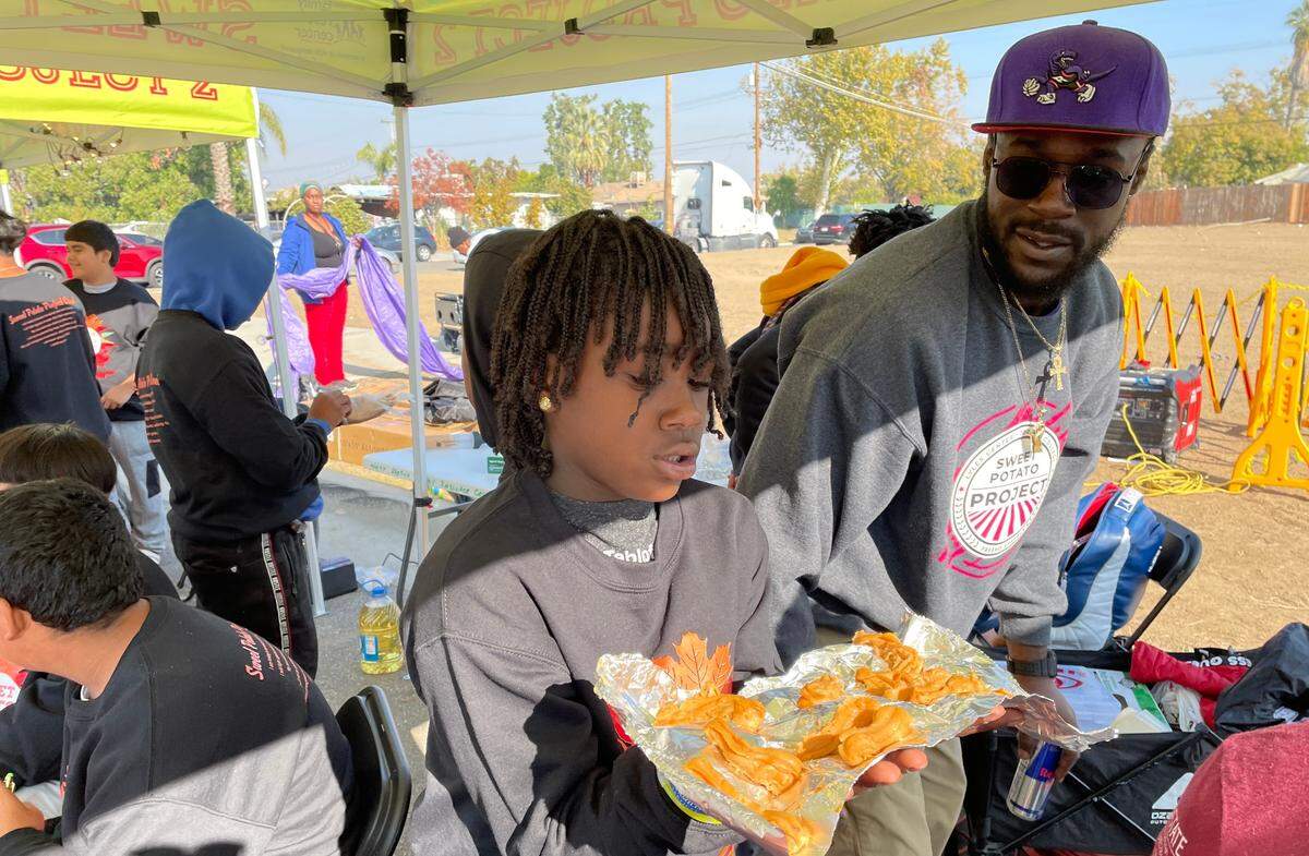 Fifth-grader Benny Britton, 10, prepares to fry sweet potato churros during the Sweet Potato Festival in Fresno, CA, on Saturday, Nov. 12, 2022.