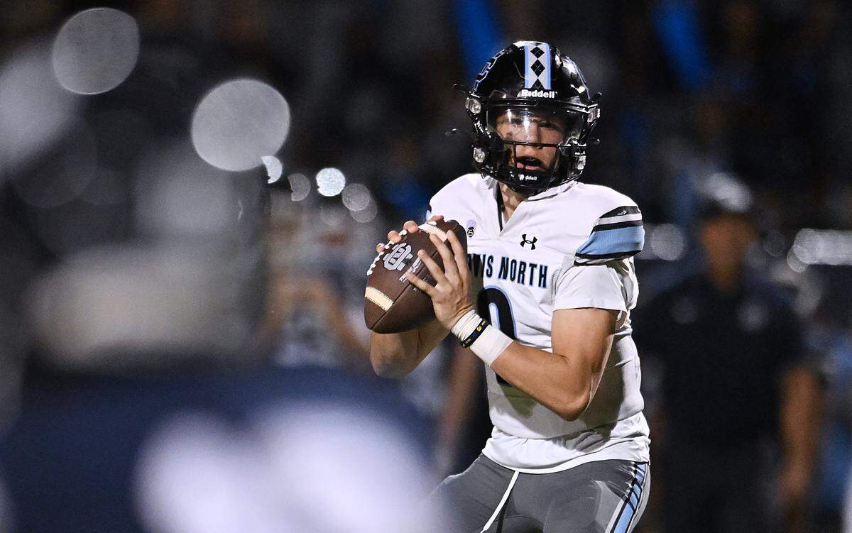Clovis North quarterback Lucas Smith prepares to throw against Redwood High Friday, Aug. 29, 2025 in Visalia. Clovis North held off Redwood for a 38-34 win.