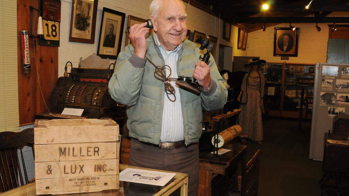 Los Banos historian Charles Sawyer checks out a 1930’s-era phone ag the Milliken Museum in Los Banos in January of 2011. Next to him is a Miller & Lux Inc. grocery box used to carry groceries home from the store. Today we use plastic bags.