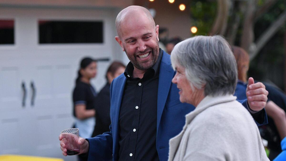 Andy Levine, left, candidate for Fresno Unified School Board, District 5, greets his mother Trudi Thom, right, at his party on election night Tuesday, April 12, 2022 in Fresno.