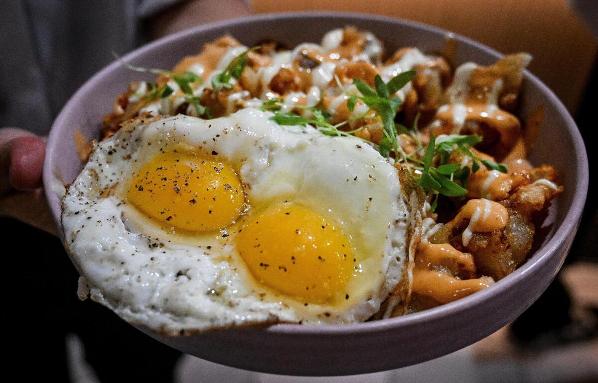 Patatas bravas — a potato dish with chipotle mayo and garlic aioli, sunnyside up eggs and chives — is served to customers during a test run for The Brunch Bar restaurant on Herndon and Willow avenues in Clovis in this file photo from 2023.