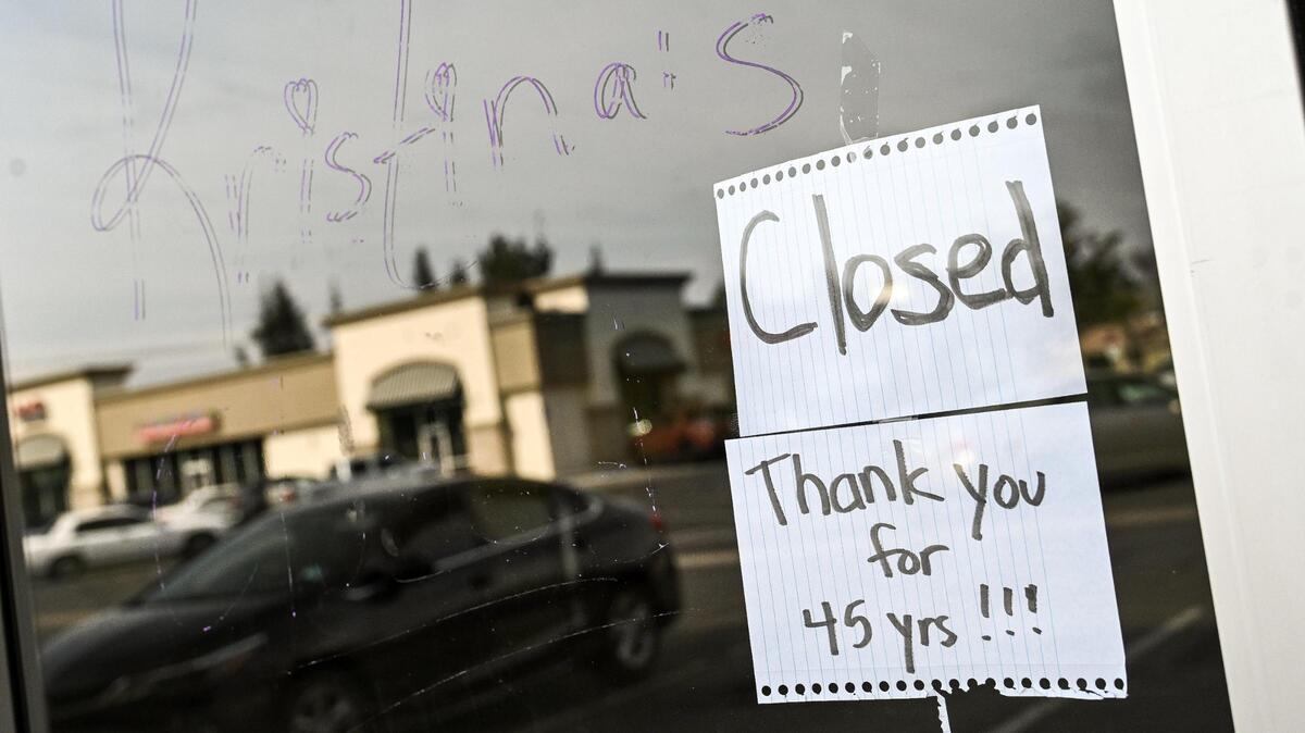 A handwritten sign taped to the window at Kristina’s Natural Ranch Market at First and Barstow tells customers that the store has closed after 45 years.