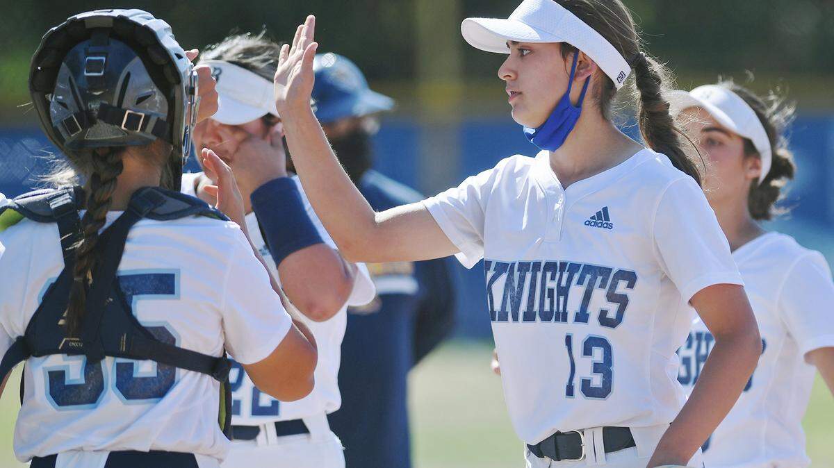 Bullard pitcher Bella Gallegos, center, high-fives teammates as they come off the field against Sunnyside Thursday, April 29, 2021 in Fresno. The Knights won 12-0 in five innings.