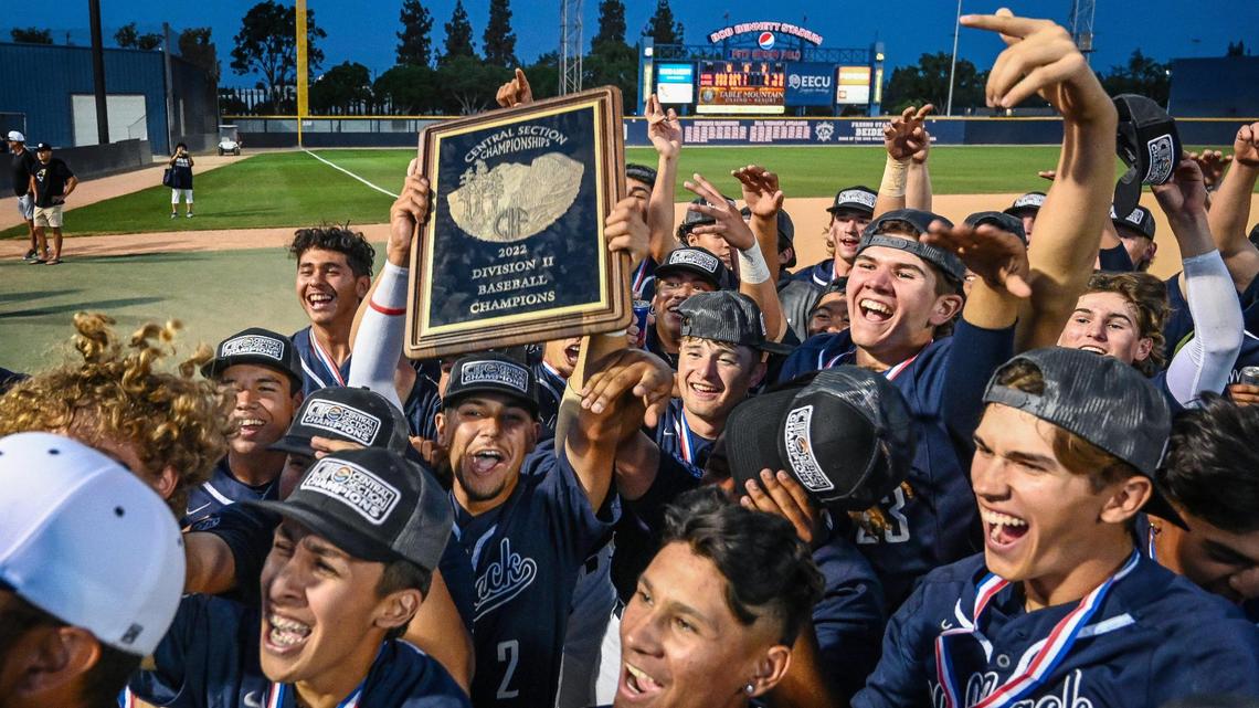 Clovis East players and staff celebrate their Central Section Division II baseball championship after defeating Central at Pete Beiden Field on Friday, May 27, 2022.