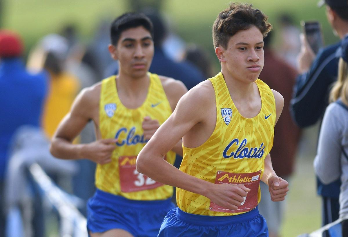 Clovis High’s Christopher Caudillo, right, leads teammate Nathaniel Avila, left, at the Central Section Boys DI cross country chamionships held at Woodward Park Thursday, Nov. 18, 2021 in Fresno. Caudillo took first, Avila placed second.