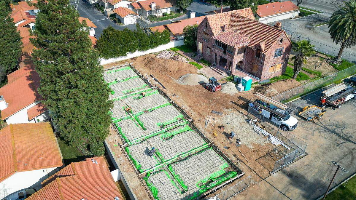 The foundation for a modern apartment building is being constructed behind the historic Craycroft Home which will be restored to its original state by local developer Reza Assemi over the next year or so.