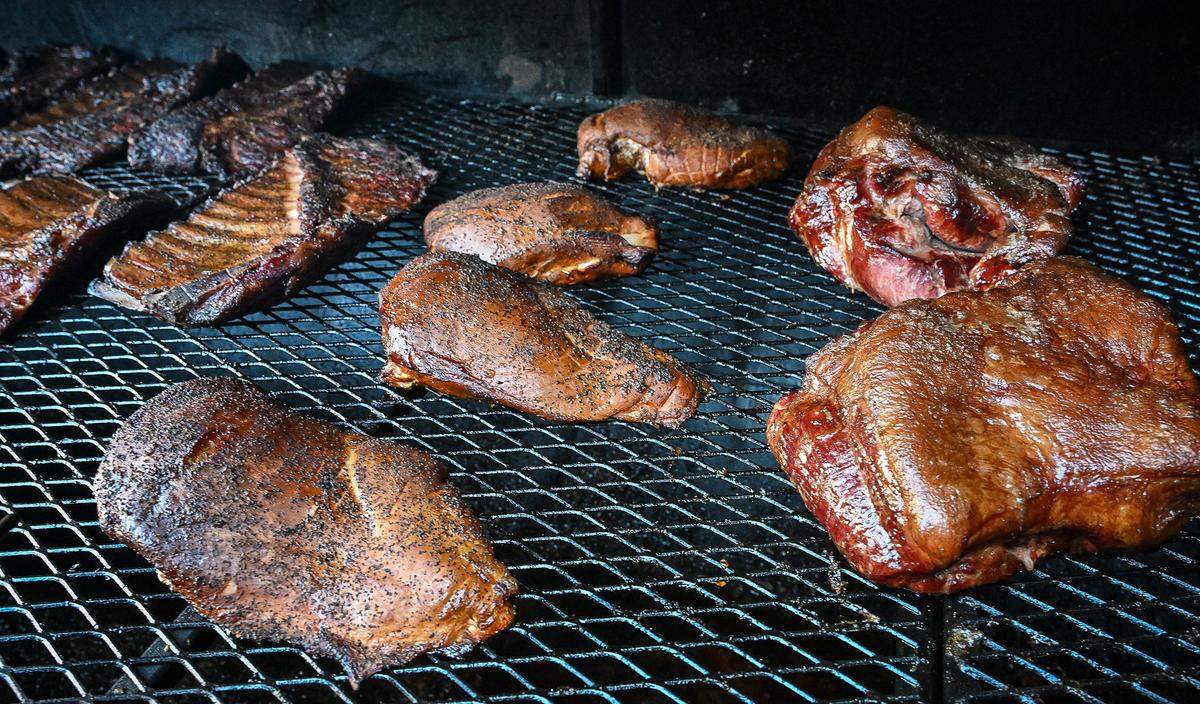 Barbecue meats including ribs, chicken, pulled pork and turkey breast sit on the smoker at Horn Barbecue, a long-anticipated barbecue restaurant that opened in Fresno on Jan. 20, 2026.