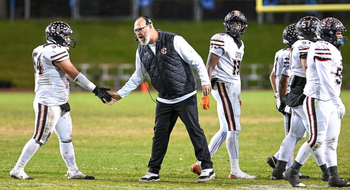 Central head football coach Kyle Biggs congratulates his players as they cruise toward a victory against Clovis North in their Central Section Division 1-AA semifinal game at Veterans Memorial Stadium in Clovis on Friday, Nov. 15, 2024.