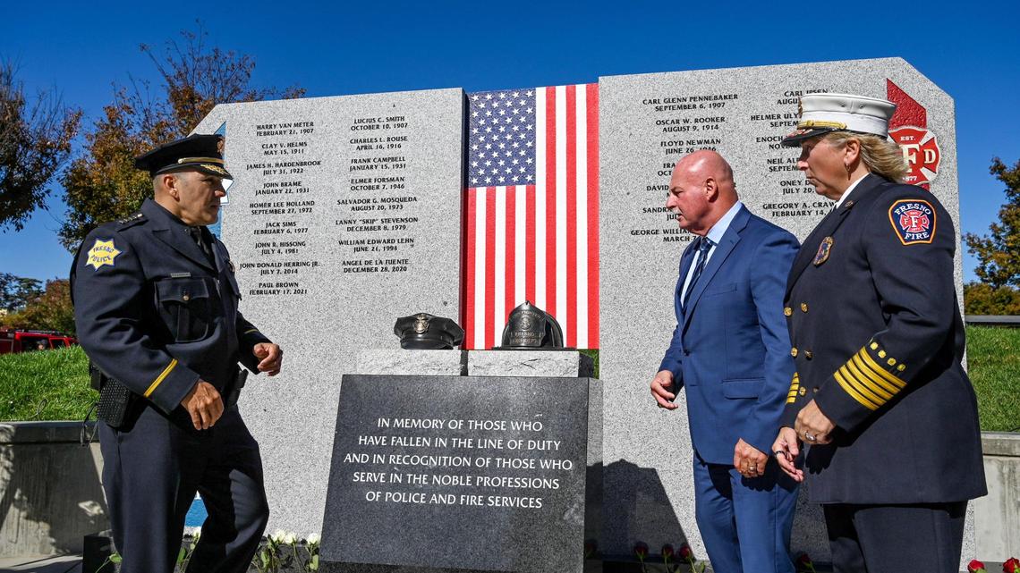 Fresno Police Chief Paco Balederrama, left, Fresno Mayor Jerry Dyer and Fresno Fire Chief Kerri Donis look over the new First Responders Memorial honoring city police officers and firefighters who lost their lives after an unveiling ceremony outside Fresno City Hall on Wednesday, Nov. 2, 2022.