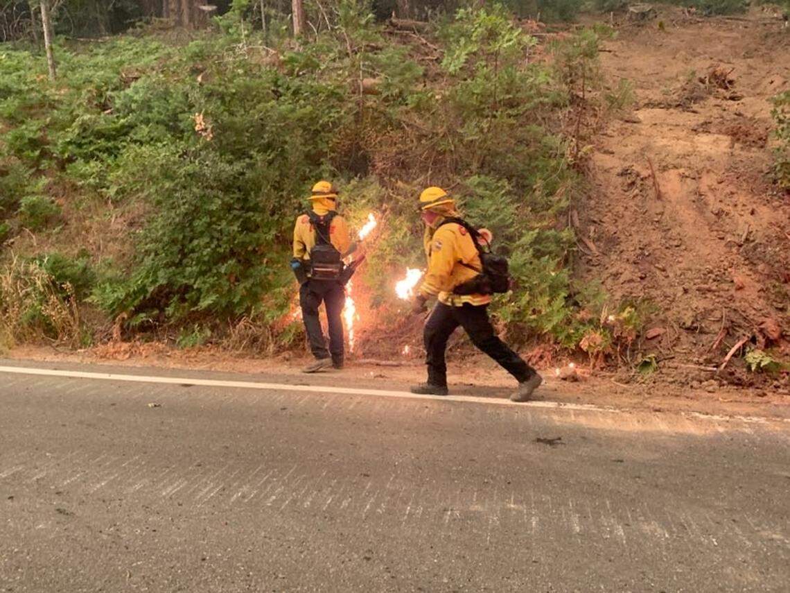 Crews set backfires in an attempt to burn away dry brush and starve the Creek Fire of fuel along Highway 168 near Lakeview Drive on Sunday, Sept. 6, 2020.