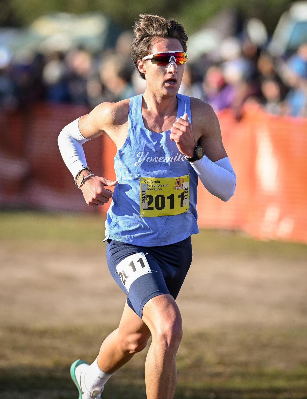 Yosemite High’s Jack Olney reaches the finish line during the boys Division V state cross country championships at Woodward Park in Fresno on Saturday, Nov. 25, 2023.