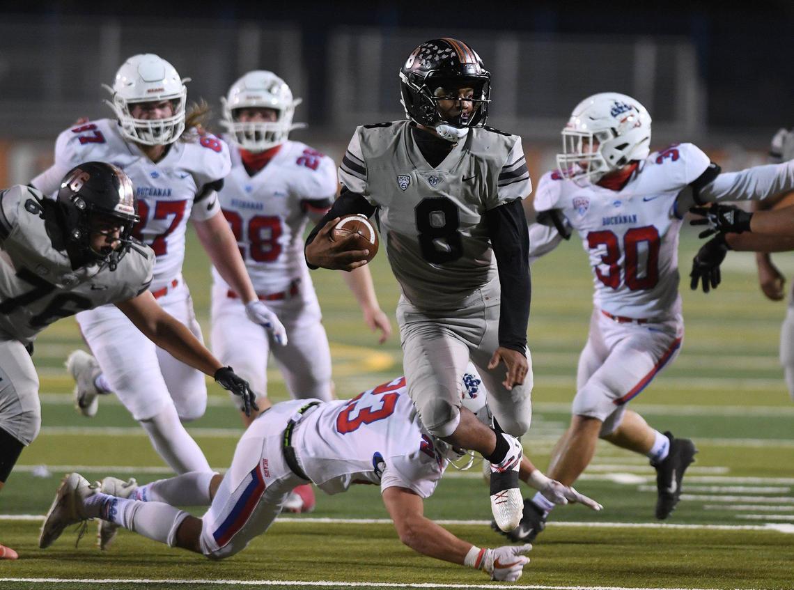 Central QB D.J. Stevenson eludes Buchanan defenders. The Bears defeated the Grizzlies 31-28 in a Tri-River Athletic Conference game on March 26, 2021 in Fresno.