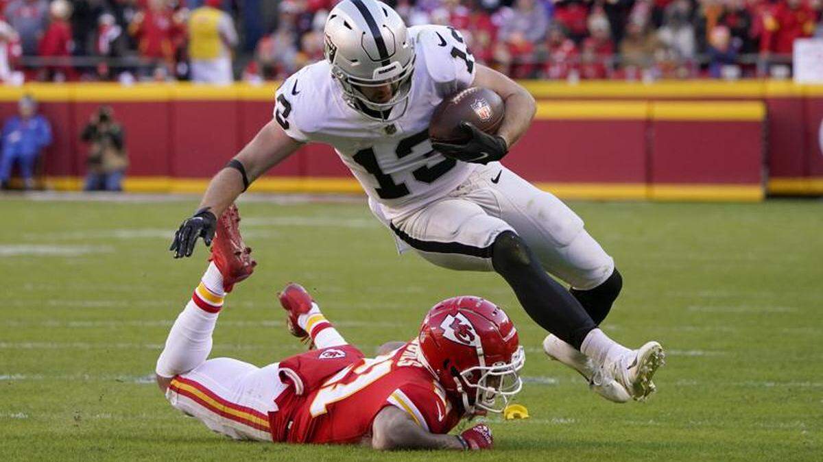 Raiders wide receiver Hunter Renfrow is stopped by former Chiefs cornerback Mike Hughes during the second half of an NFL game Sunday, Dec. 12, 2021, in Kansas City, Mo.