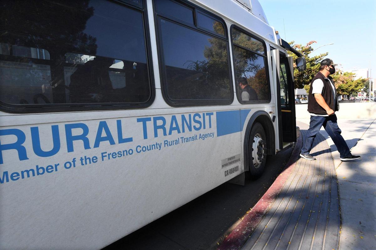 A passenger gets off one of the Fresno County Rural Transit Agency buses, this one from Huron/Coalinga, at the county courthouse, Oct. 28, 2021.