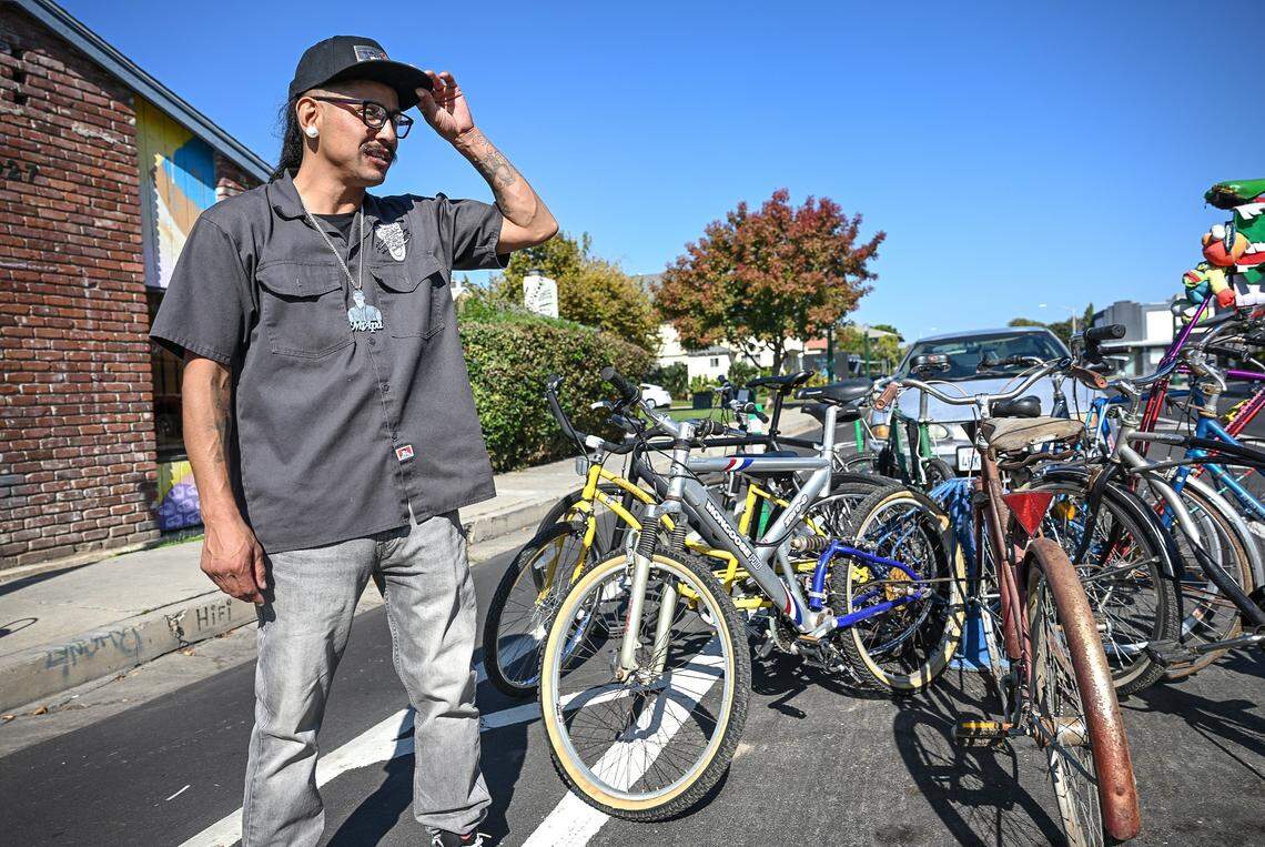 Luis Rodriguez looks over his bikes outside his Fresno bike shop, Grizzalley Bike Shope, on the southern edge of the Tower District.