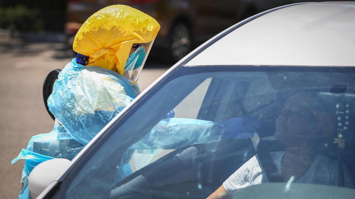 Certified medical assistant Selina Gomez from Clinica Sierra Vista in Fresno tests a patient for COVID-19 at the drive-up testing area at the facility in August. Sites like this could be relied on to distribute the coronavirus vaccine.