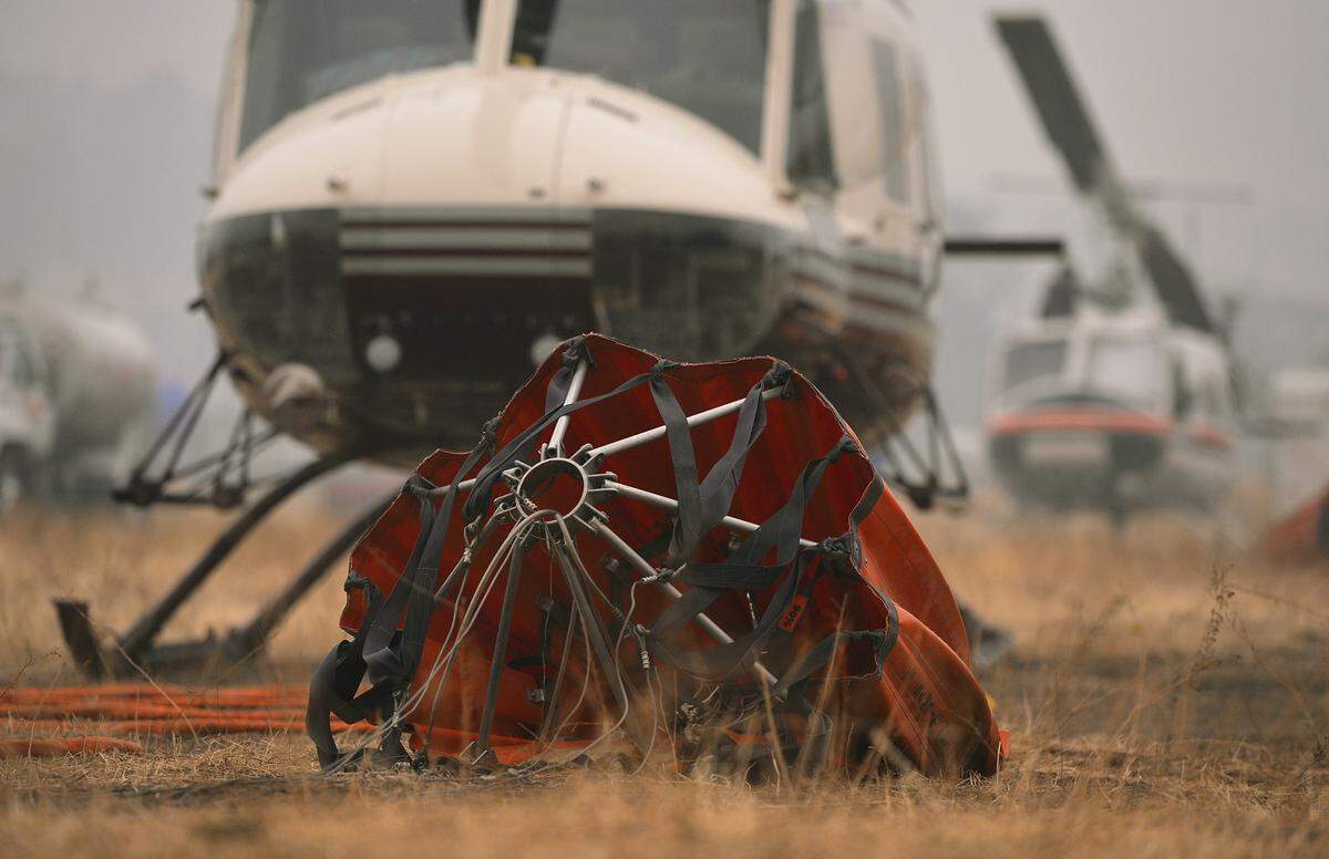 A Bambi Bucket is seen while helicopters remain on the ground, socked in by heavy smoke at the Auberry heli-base located near the southern perimeter of the Creek Fire Friday morning, Sept. 11, 2020.