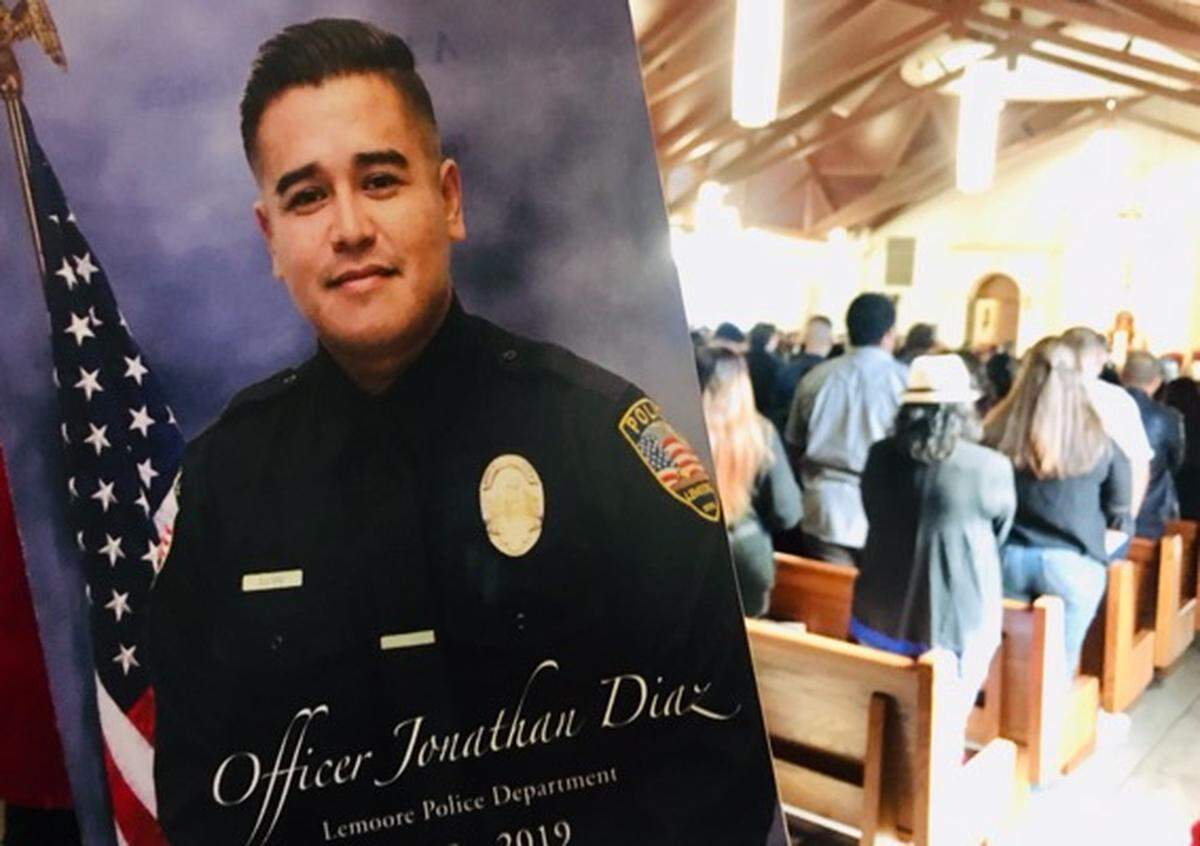 A funeral program for Lemoore Police Officer Jonathan Diaz inside a full Saint Peter Prince of the Apostles Catholic Church in Lemoore on Nov. 15, 2019 during his funeral mass.