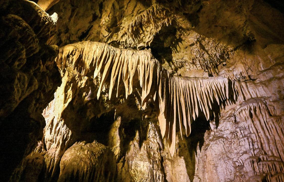 Calcium carbonate formations appear above the fairy pools in Crystal Cave where visitors can once again see inside the ancient cave after it’s reopening following years of being closed.