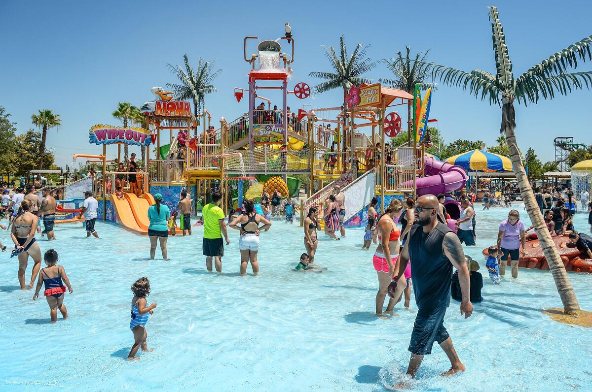 Visitors prepare to be doused by a bucket filling with water at the top of the play structure in Ohana Bay at Island Waterpark on a hot afternoon in Fresno on Saturday, July 27, 2019.