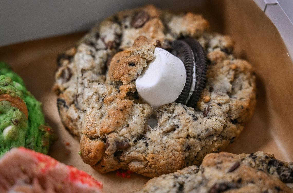 A s’more Oreo chunky cookie packaged with a sampler pack of Asian cookies from Saint Goods at their workplace inside the Clovis Culinary Center on Wednesday, Nov. 15, 2023.