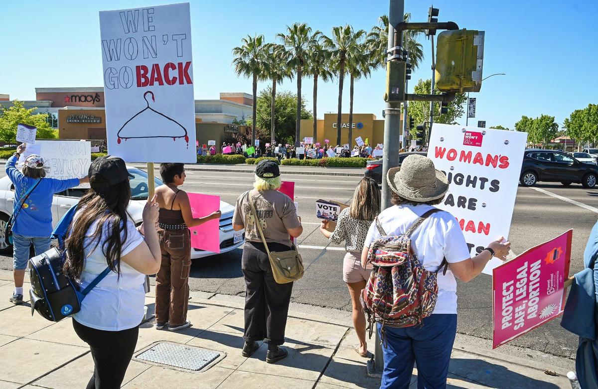 Protesters stand on all corners of Blackstone Avenue at Nees near the River Park shopping center in Fresno during a rally in support of Roe v. Wade on Saturday, May 14, 2022.
