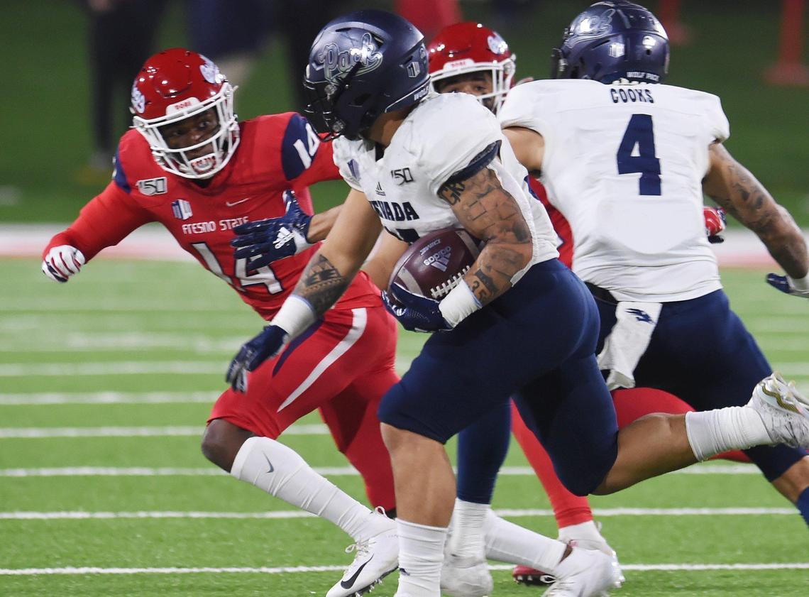 Fresno State cornerback Jaron Bryant, left, chases Nevada running back Toa Taua in the Bulldogs’ 35-28 loss to the Wolf Pack Saturday, Nov. 23, 2019 in Fresno. Taua rushed for 135 yards and one touchdown on 20 plays.