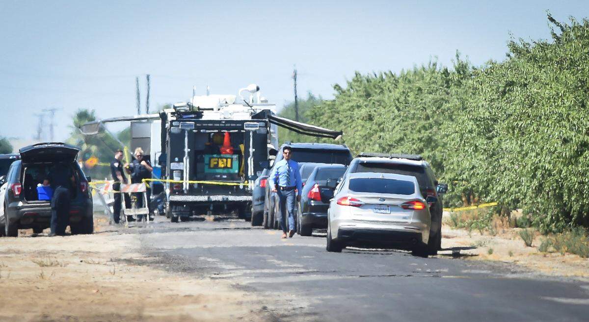 Crime scene investigators, including the FBI, converge on a almond orchard on on Road 21 north of Avenue 14 west of Madera where a body was found Thursday July 23, 2020, possibly that of the missing 2-year-old Madera boy.