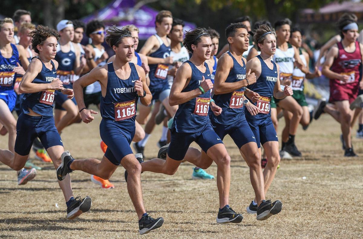 Members of the Yosemite High boys cross country team start their Central Section boys Division V cross country race at Woodward Park in Fresno on Thursday, Nov. 17, 2022.