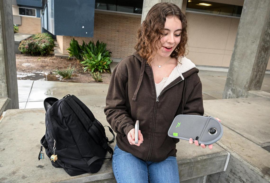 Bullard High School junior Adeline Mendoza shows her Yondr pouch before putting her cell phone inside to be locked away for the day on Monday, Jan. 22, 2024. Phones go into the pouches and stay locked inside until after the school day ends when they can be unlocked with a magnetic device.
