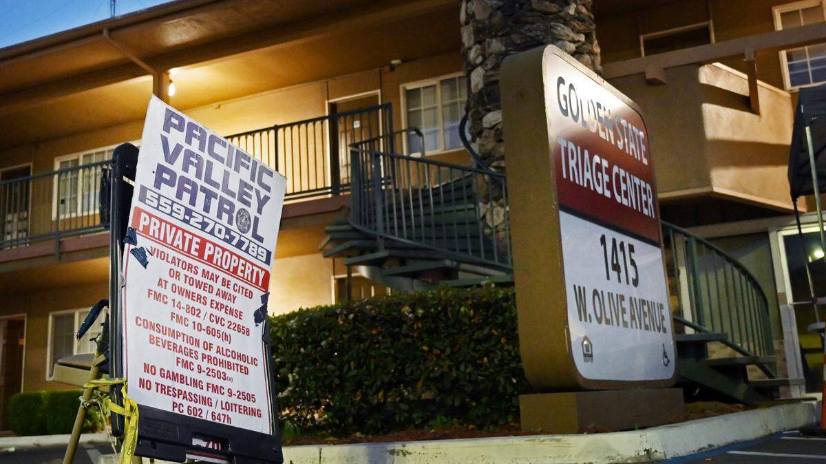 Pacific Valley Patrol security guards maintain a station outside the Golden State Triage Center, a former motel turned into housing for the homeless Tuesday, April 5, 2022 in Fresno. A new security firm will take over operations in April 2023.
