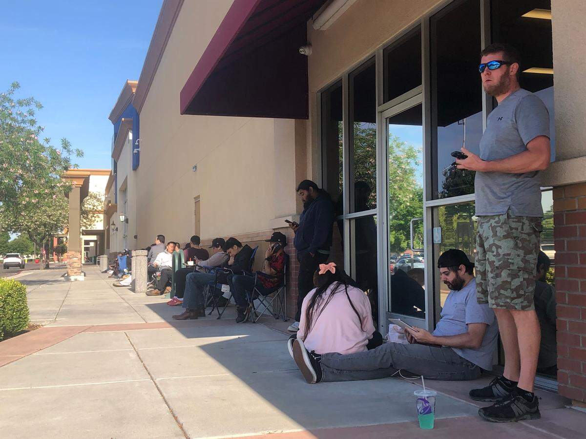 Roughly 40 people waited outside of a BestBuy to try to purchased a coveted Pokemon card collectors box with some having camped out overnight and in line for more than 12 hours.