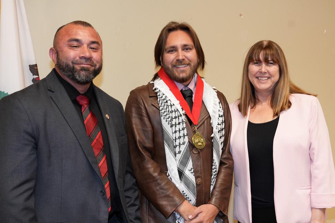 Gavin ‘Gavino Garza (center) graduated from Fresno City College in May as this year’s Dean’s Medallion of Excellence Award recipient for Humanities Division. Pictured are FCC president Dr. Robert Pimentel (left) and Kerry McCutcheon, dean of instruction for FCC Humanities division (right).