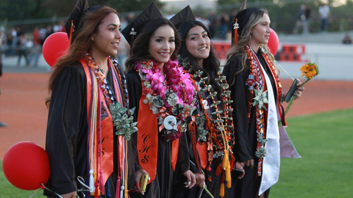 Coalinga High School graduating seniors walked into the stadium holding red balloons for the start of the commencement ceremony at Chuck Garten Memorial Bowl on June 2.