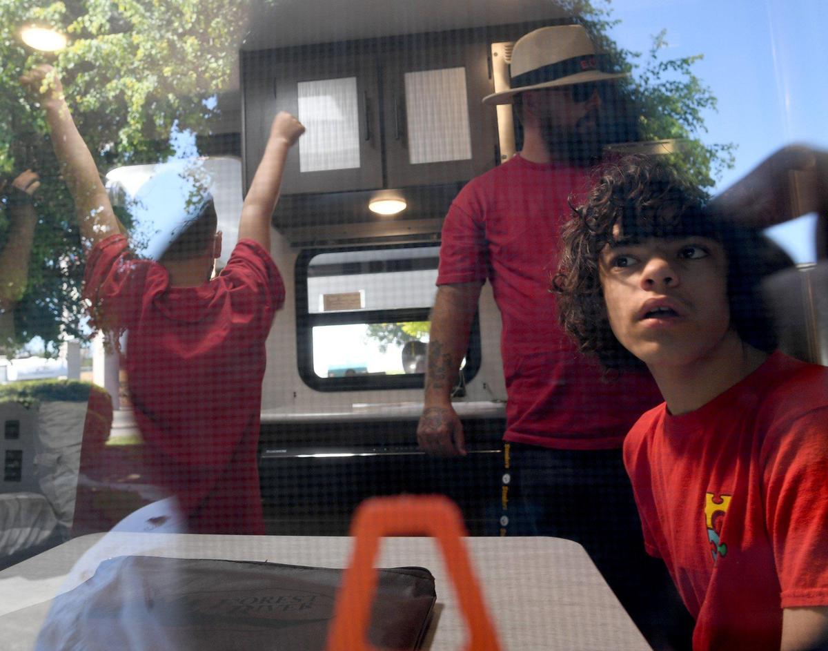 13-year-old Christopher Reny, Brennan Reny’s twin brother, checks out the interior of the family’s new travel trailer, which they were presented with as a Make-A-Wish gift for Brennan, through the foundation and RV Country, Tuesday Aug. 17, 2021.