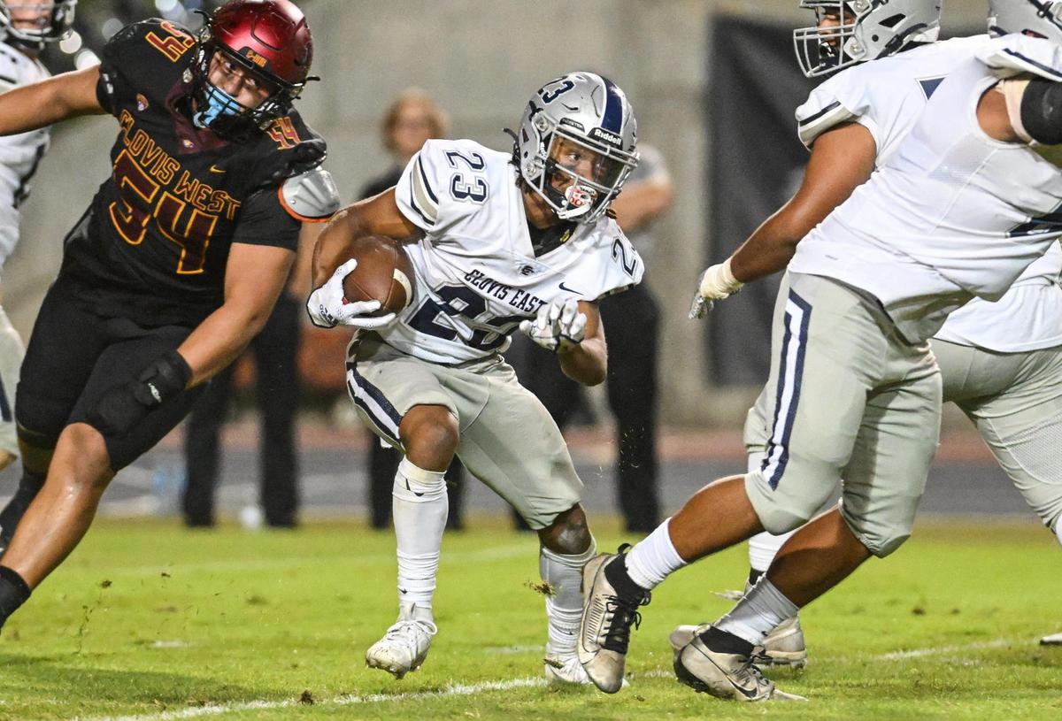 Clovis East’s Lindsey Graves, center, looks for an opening on a run against Clovis West during their game at Veterans Memorial Stadium in Clovis on Friday, Oct. 6, 2023.