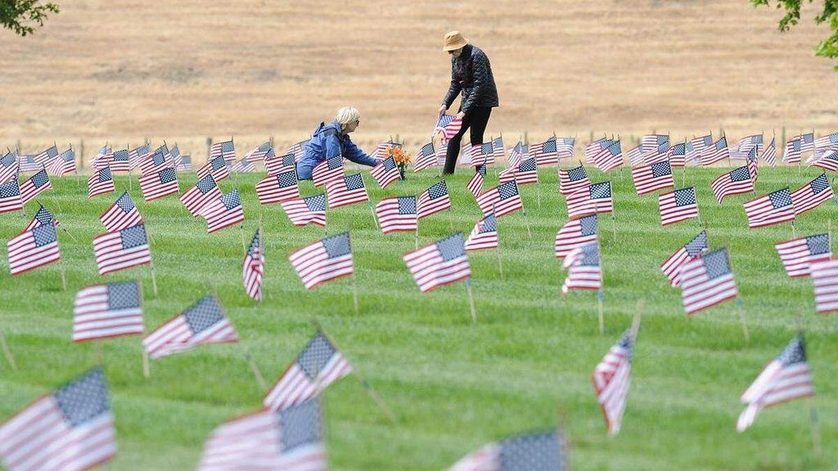 Following a Memorial Day ceremony at the San Joaquin Valley National Cemetery in Santa Nella, family members are shown visiting the graves of their loved ones.
