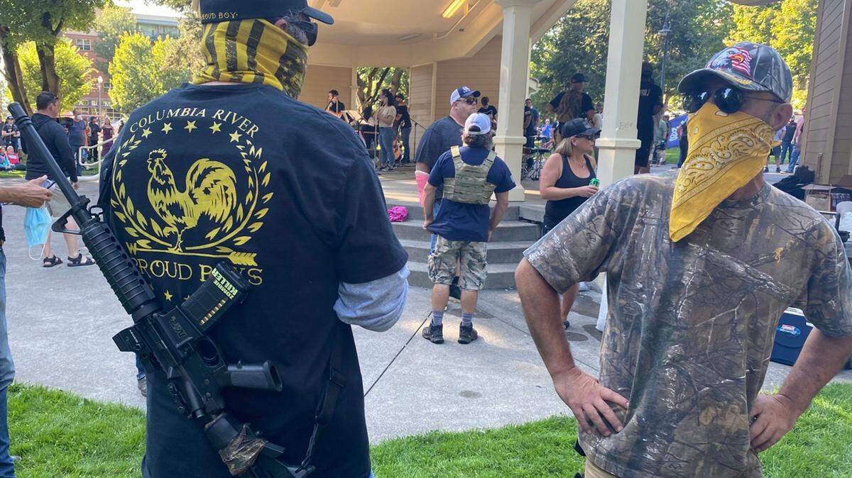 A Proud Boys member stands guard at a memorial gathering for Aaron “Jay” Danielson, who was shot to death in Portland, Ore. during clash between pro-Trump and left-wing protesters.