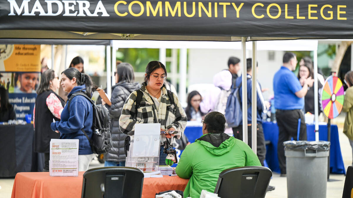 Vendors speak to job applicants during an annual job fair at Madera Community College on Tuesday, March 4, 2025.