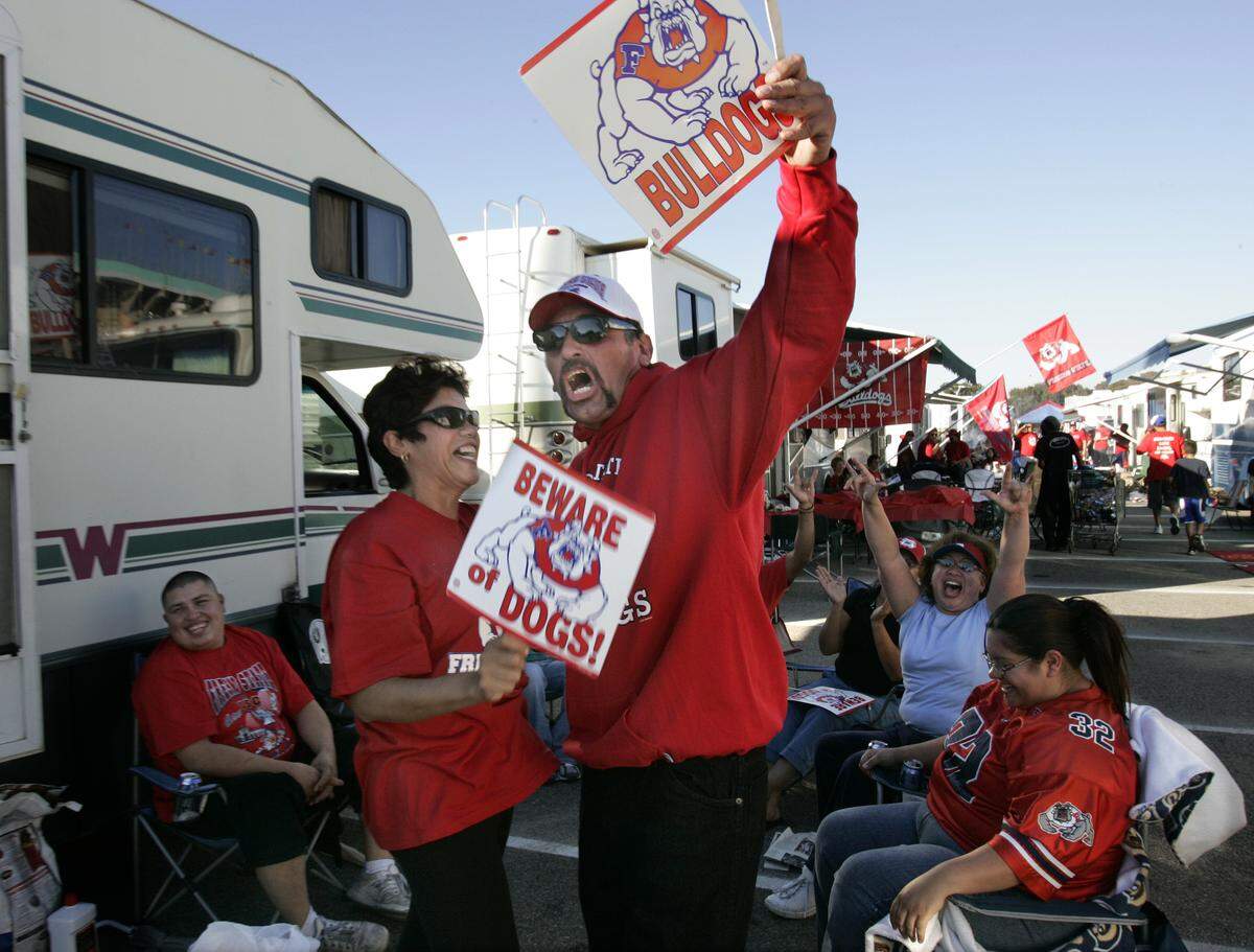 Soyla Quiroz and Primitivo Salazar of Selma cheer for the Fresno State Bulldogs before the Fresno State USC football game on a beautiful sunny afternoon in front of the Los Angeles Memorial Coliseum on Saturday, Nov. 19, 2005..