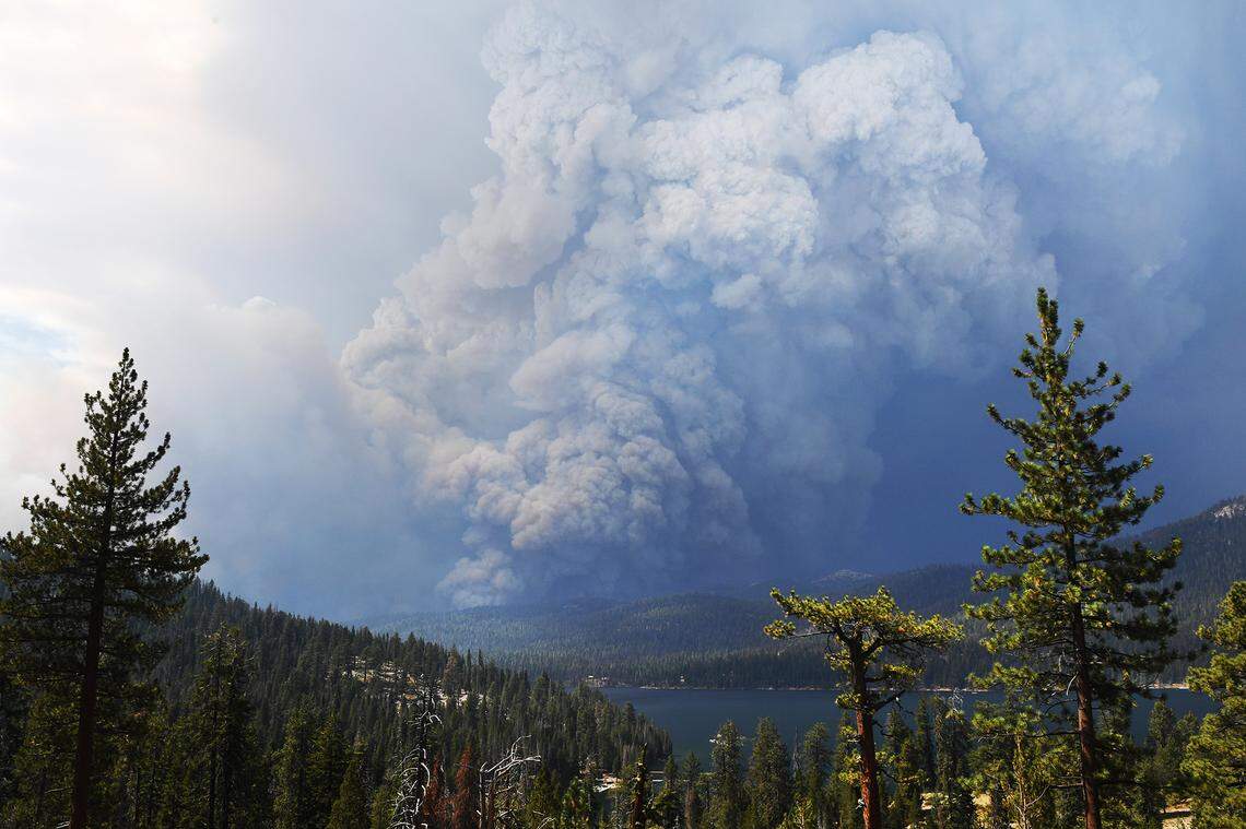 Smoke from the Creek Fire billows into the sky beyond Huntington Lake in the foreground on Saturday, Sept. 5, 2020.